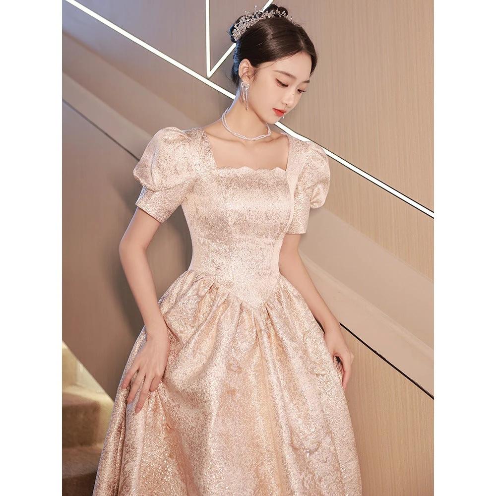 Elegant women’s champagne evening dress by Ancient Energy, featuring a flowing design and sophisticated style for special occasions.