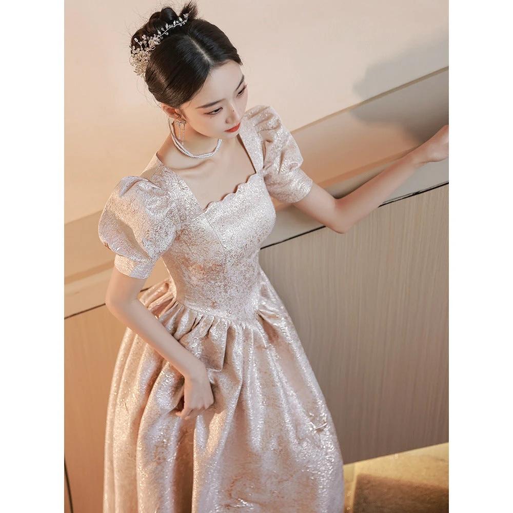 Elegant women’s champagne evening dress by Ancient Energy, featuring a flowing design and subtle shimmer for formal occasions.