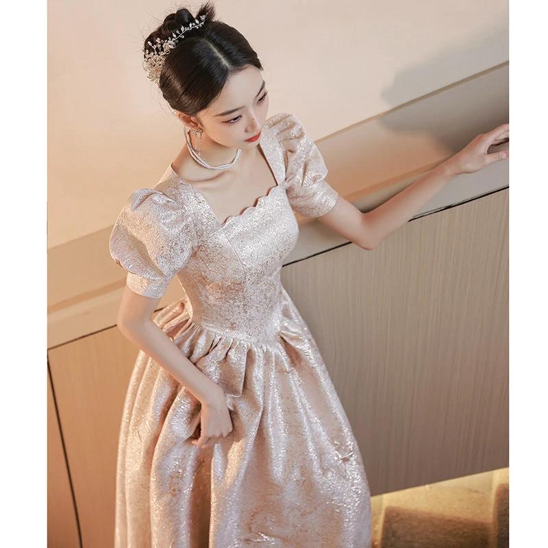 Elegant champagne-colored women evening dress by Ancient Energy, featuring a flowing design and stylish silhouette.