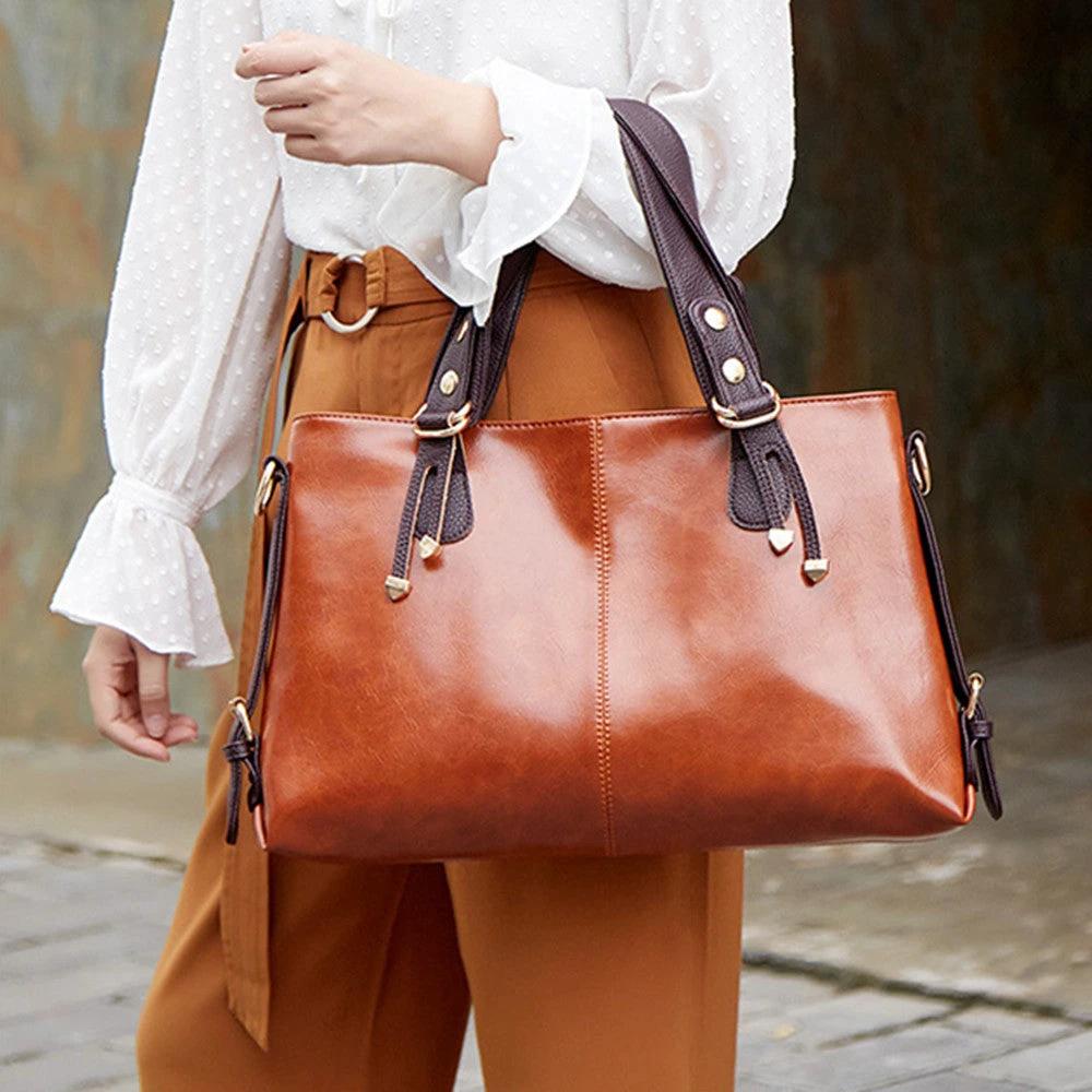 Large soft leather women's shoulder messenger handbag by Ancient Energy with spacious interior and sturdy straps.