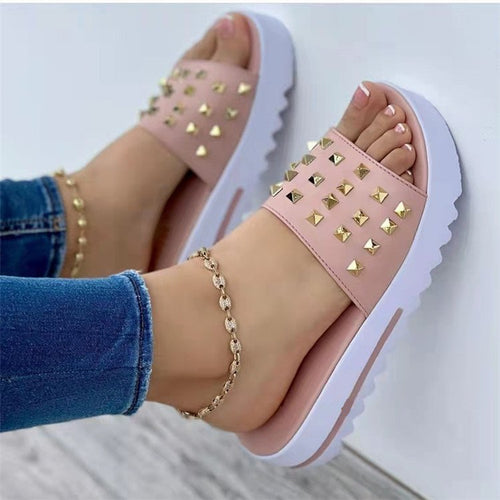 Women's wedge and rivet beach flip-flops by Ancient Energy with cork wedge heel and stylish rivet details, perfect for summer footwear.