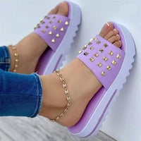 Women's wedge and rivet beach flip-flops by Ancient Energy featuring tan straps and a comfortable wedge sole.