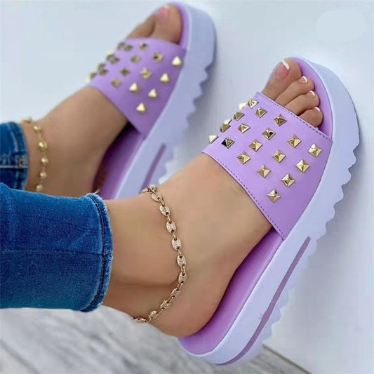 Women's wedge and rivet beach flip-flops by Ancient Energy featuring tan straps and a comfortable wedge sole.