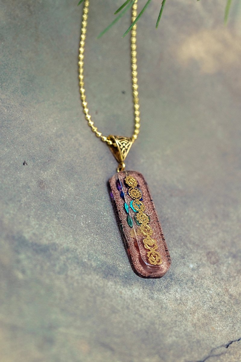 7 chakra Orgone copper pendant with chain from Ancient Energy, featuring colorful chakra stones and intricate metalwork.