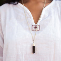 Silver-plated Black Tourmaline protection pendant from Ancient Energy featuring a polished stone and intricate silver setting.
