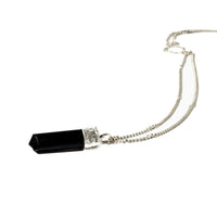Silver-plated Black Tourmaline Protection Pendant from Ancient Energy, showcasing a polished black gemstone on a silver chain.