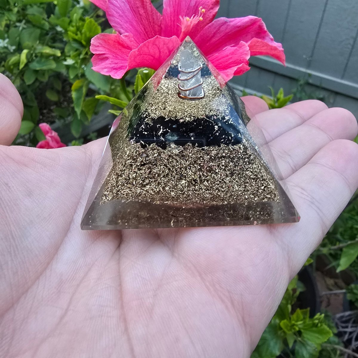 Mini orgone protection pyramid made of brass, copper, and black tourmaline by Ancient Energy, with a sleek black finish and intricate design.