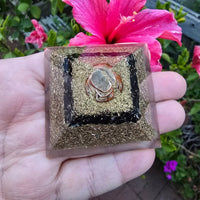 Mini orgone protection pyramid by Ancient Energy featuring brass, copper, and black tourmaline for spiritual shielding.