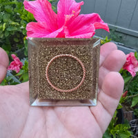 Mini orgone protection pyramid with brass, copper, and black tourmaline, designed for spiritual shielding and energy balance.