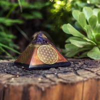 Ancient Energy Flower of Life Copper Orgone Pyramid with Amethyst crystal, detailed design, and vibrant purple gemstone accents.
