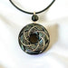 Ancient Energy Torus Vortex pendant necklace featuring Shungite orgonite and Rodin coil design, resting against a neutral background.