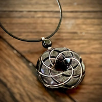 Ancient Energy Torus Vortex pendant necklace with shungite orgonite and Rodin coil, featuring a sleek, handcrafted design.