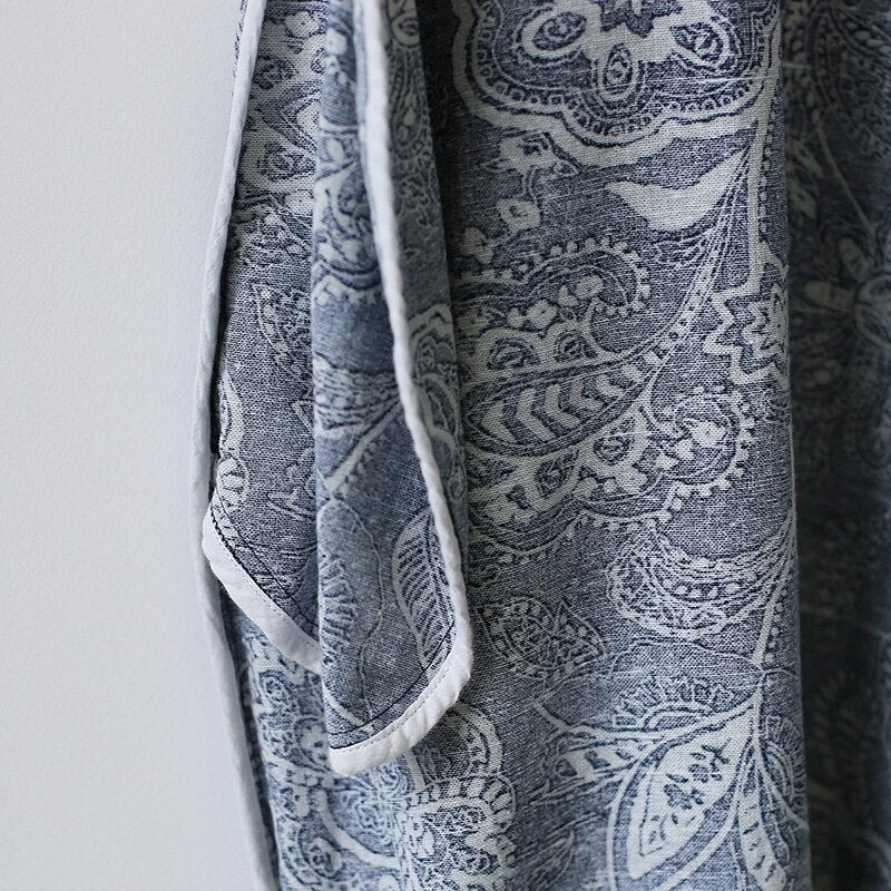 Mandotos International retro floral cotton dress with side slit, featuring a vibrant pattern and flowing silhouette.