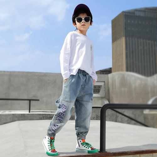 Boys' loose Western style jeans and trousers for primary school students by Ancient Energy, shown in a casual school outfit.