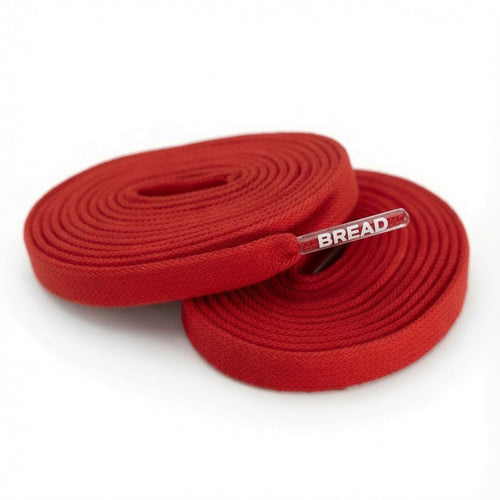 Bright red elastic shoelace by Bread, featuring a flexible, stretchable design perfect for athletic and casual shoes.