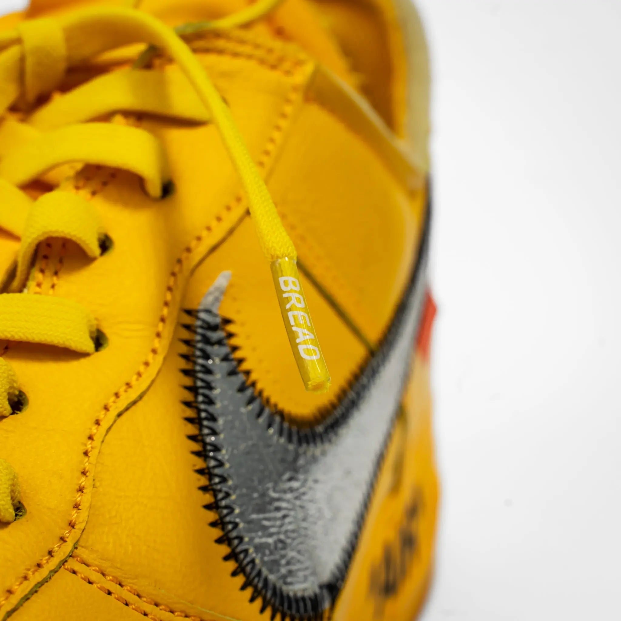 Elastic shoelace in bright yellow by Bread, designed for easy slip-on shoes, shown with the Corona Yellow style.