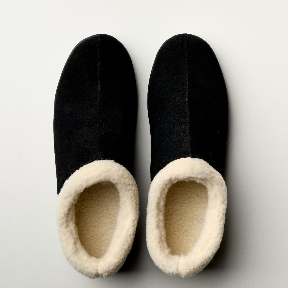 Men's Bread Ashton suede slippers with soft lining and slip-on design, shown in a cozy indoor setting.