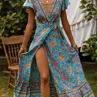 Mandotos International Tropical Bloom Maxi Dress with vibrant floral pattern and flowing fabric, perfect for summer events.
