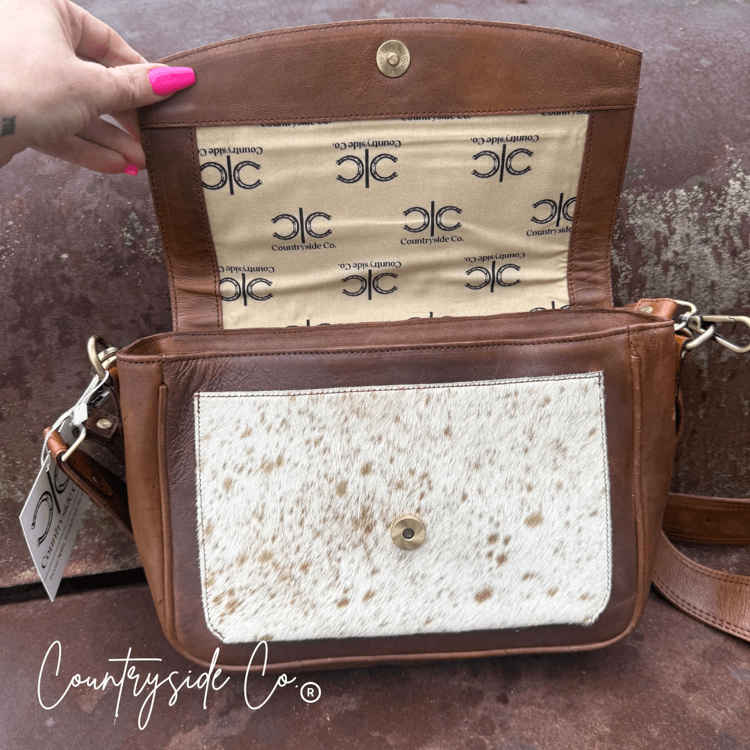 Grace Tooled Leather Purse by Countryside Co. with intricate tooling, featuring a compact design and adjustable strap.