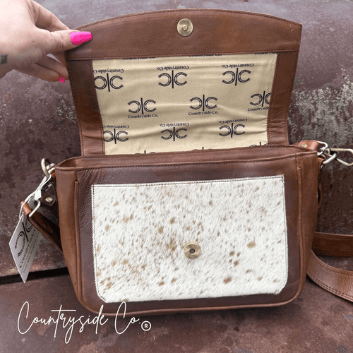 Grace Tooled Leather Purse by Countryside Co. with intricate tooling, featuring a compact design and adjustable strap.