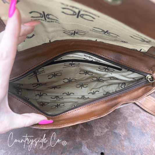 Grace Tooled Leather Purse by Countryside Co. featuring intricate tooling and a classic design, shown in a close-up view.