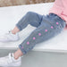 Girls' casual thin love stretch jeans by Ancient Energy, showing a close-up of the slim-fit denim with a light wash and stretchy fabric