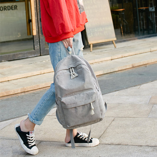 Ancient Energy corduroy backpack for students with shoulder straps and multiple compartments, ideal for school and everyday use.
