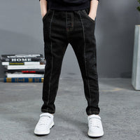 Boy wearing navy velvet one-piece jeans for autumn and winter by Ancient Energy, featuring a comfortable, stylish design.