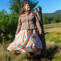 Colorful sari wrap skirt by Darn Good Yarn, showcasing vibrant fabric and traditional design, styled as a versatile clothing accessory.