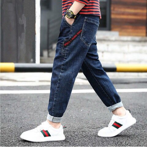Young boy wearing blue denim trousers from Ancient Energy, casual children's clothing with a relaxed fit and classic style.