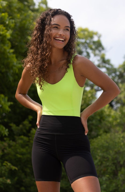 Elastique Athletics Riviera Bodysuit, fitted black bodysuit with scoop neckline and long sleeves for activewear and casual wear.