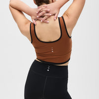 Elastique Athletics Lisse Bra in chestnut and black, showcasing its sleek, supportive tops design with a comfortable fit.
