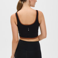 Elastique Athletics Lisse Bra in Chestnut and Black, showcasing a fitted athletic top with supportive design and moisture-wicking fabric.