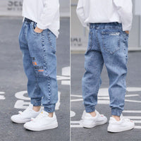 Young boy wearing blue boys' jeans from Ancient Energy’s spring and autumn collection, casual style and comfortable fit.