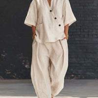 FitiqueFit two-piece set with a V-neck short sleeve top and high-waist trousers, displayed on a neutral background.
