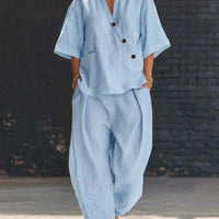 FitiqueFit V-neck short sleeve top and high-waist trousers two-piece set, displayed on a model. Stylish and casual fashion ensemble.