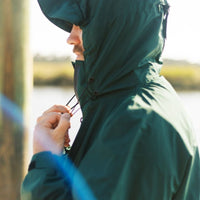 IWOM WeatherShield Convertible Jacket shown in black, featuring a hood and multiple zipper pockets for versatile weather protection.