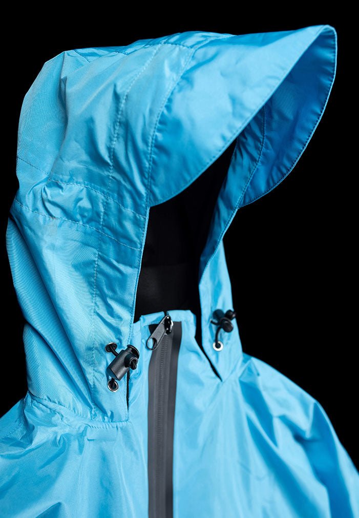 IWOM WeatherShield Convertible Jacket shown in dark gray with adjustable hood and multiple zippered pockets, outdoor waterproof outerwear