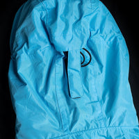 IWOM WeatherShield Convertible Jacket shown in navy, featuring a zip-off hood, multiple pockets, and adjustable cuffs for versatile outdoor wear.