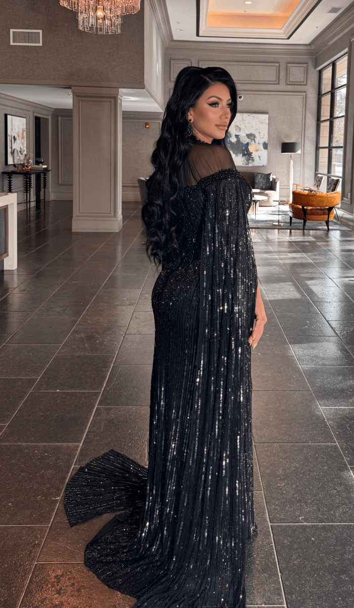 Iyza Belaar Hosna long sleeve dress with drape and sequin embellishments, featuring a modest design perfect for special occasions.