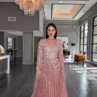 Elegant Inaya Long Drape Sleeves Beaded A-line gown by Iyza Belaar, featuring intricate beadwork and flowing fabric.