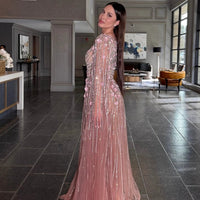 Iyza Belaar Inaya long drape-sleeves beaded A-line gown, elegant evening dress with intricate beadwork and flowing fabric.
