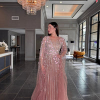 Elegant Inaya long drape sleeves beaded A-line gown by Iyza Belaar, featuring intricate beadwork and flowing fabric.