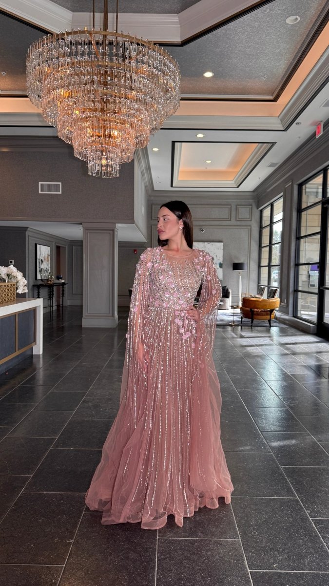 Elegant Inaya long drape sleeves beaded A-line gown by Iyza Belaar, featuring intricate beadwork and flowing fabric.