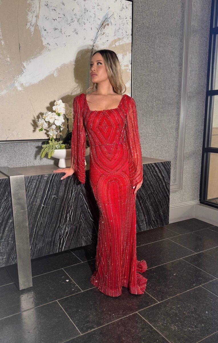 Red beaded modest gown with long drape sleeves by Iyza Belaar, featuring intricate beadwork and elegant design.