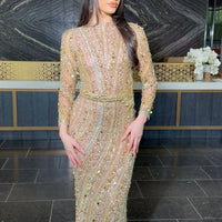 Iyza Belaar Mariam long sleeve beaded dress, elegant evening dress with intricate bead detailing and flowing fabric.