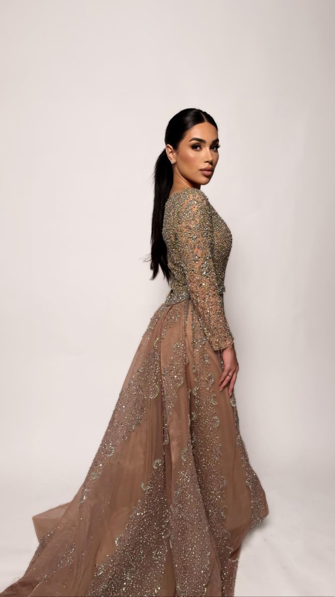 Iyza Belaar Aleya beaded removable embellished sequin overskirt over a long dress, detailed beading and embroidery visible.