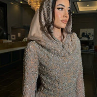 Iyza Belaar Aleya embellished scarf styled as a long dress hijab headwrap with intricate embellishments and elegant design.