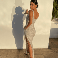 Iyza Belaar Angelina long dress with pearl embellishments and beadwork, featuring a flowing silhouette and elegant design.