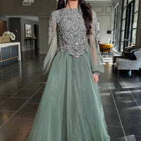 Elegant sage green Ashira long sleeve ball gown by Iyza Belaar, featuring a flowing long dress design.